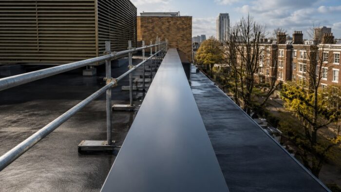 Parapet Wall Coping: The Complete UK Guide to Materials, Types, Installation and Specification 9 Panoramic rooftop with bronze parapet wall coping and open countryside background