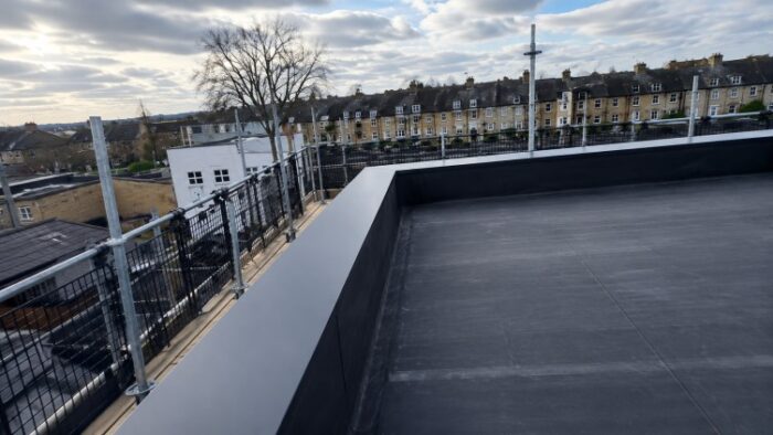 Parapet Wall Coping: The Complete UK Guide to Materials, Types, Installation and Specification 7 Flat roof terrace with dark parapet wall coping and wide urban residential view