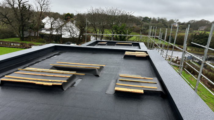 Aluminium Coping Prices: What Affects the Cost of Parapet Wall Coping 4 Aluminium coping prices for a completed dark grey parapet coping system around a flat roof on a UK residential property.