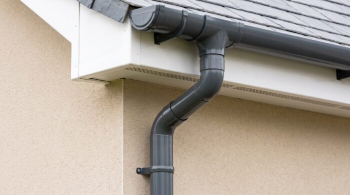 Round Downpipe Guide for UK Rainwater Goods 5 Round downpipe on a modern commercial building with a clean aluminium rainwater system and premium exterior detail.