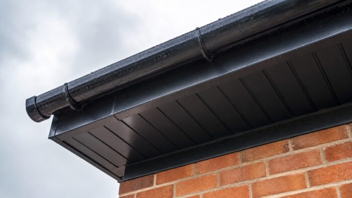 Â Soffits and Fascia Boards: A Complete UK Roofline Guide 4 Soffits and fascia boards shown in a close roof detail view after rainfall