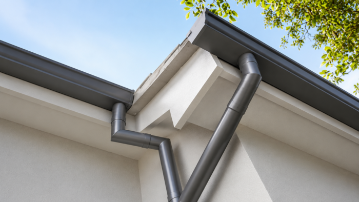 Square to Round Downpipe: Plan the Transition Properly 6 Square to round downpipe in an aluminium grey finish forming part of a coordinated rainwater system.