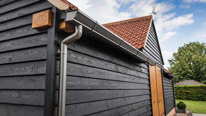 Square to Round Downpipe: Plan the Transition Properly 7 Square to round downpipe installed on a UK property with matching aluminium gutter and roofline details.