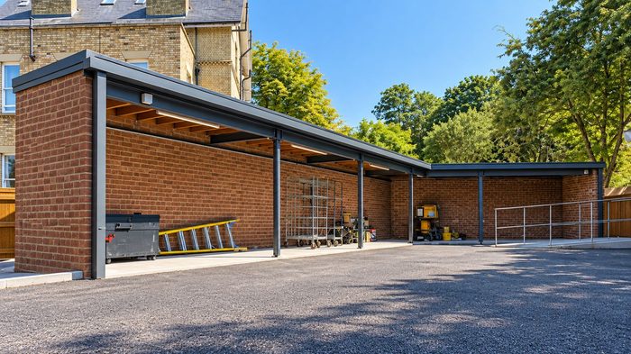 How to Choose the Best Box Gutter Material for UK Buildings 5 Box Gutter Material connected to a square downpipe on a traditional brick school building