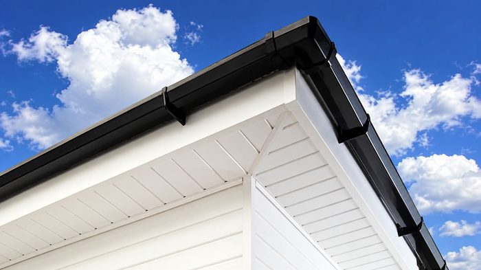 How to Choose House Fascia for a Durable UK Roofline 4 House fascia in deep grey with matching soffit and black guttering on a UK brick home