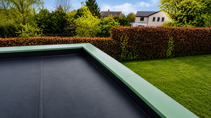 Modern garden roof terrace with green parapet wall coping and clean flat roof finish