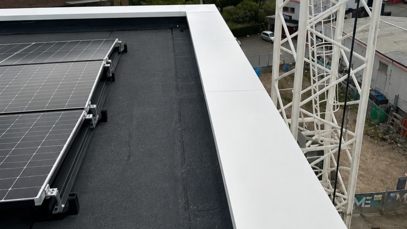 Cheapest aluminium coping detail on a flat roof showing parapet edge and rainwater protection.