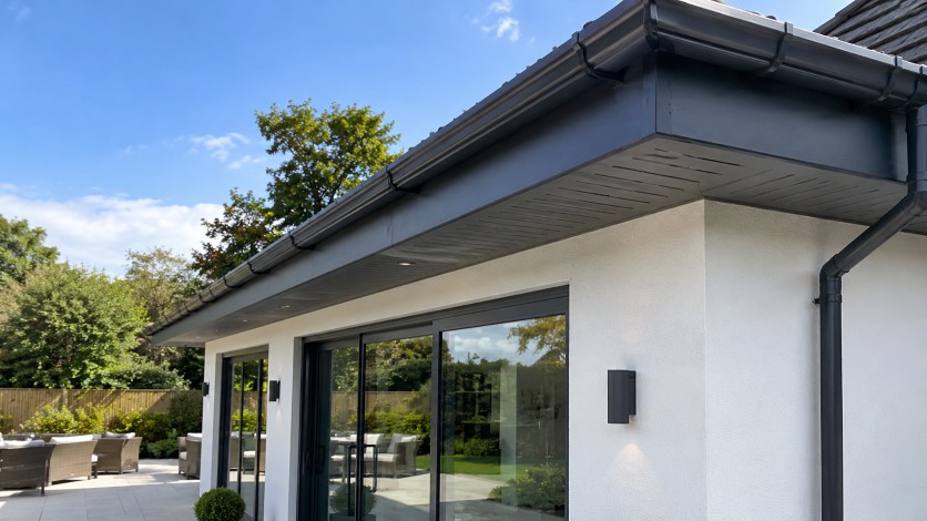 Soffits and fascia boards on a suburban brick home with clean roofline details